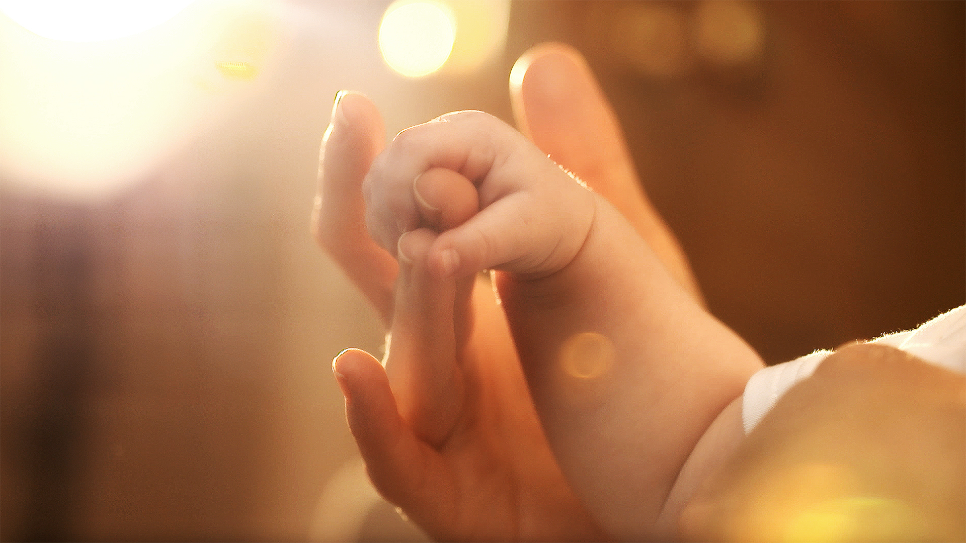 A babies tiny fist gasps a parents finger. It's a metaphor for being awed.