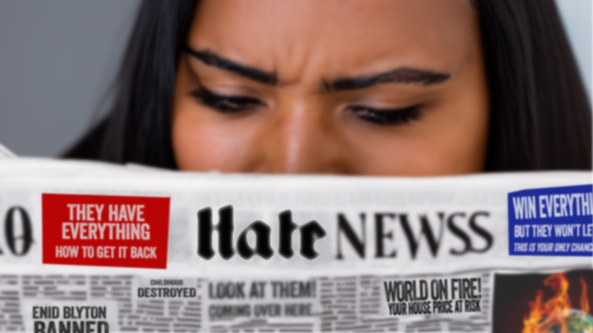 Holding up a copy of Hate News, a frowning reader feels the weight of the world on her shoulders